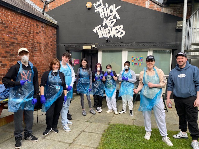 Group of students from People 1st in Lurgan with Thick as Thieves Graffiti artists, standing with aprons and masks on ready to spray. 