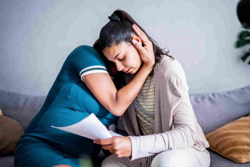 mum consoling a upset daughter after GCSE results day
